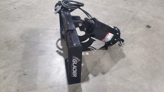 Heavy-duty hydraulic auger attachment with hoses and Glacier logo on concrete floor